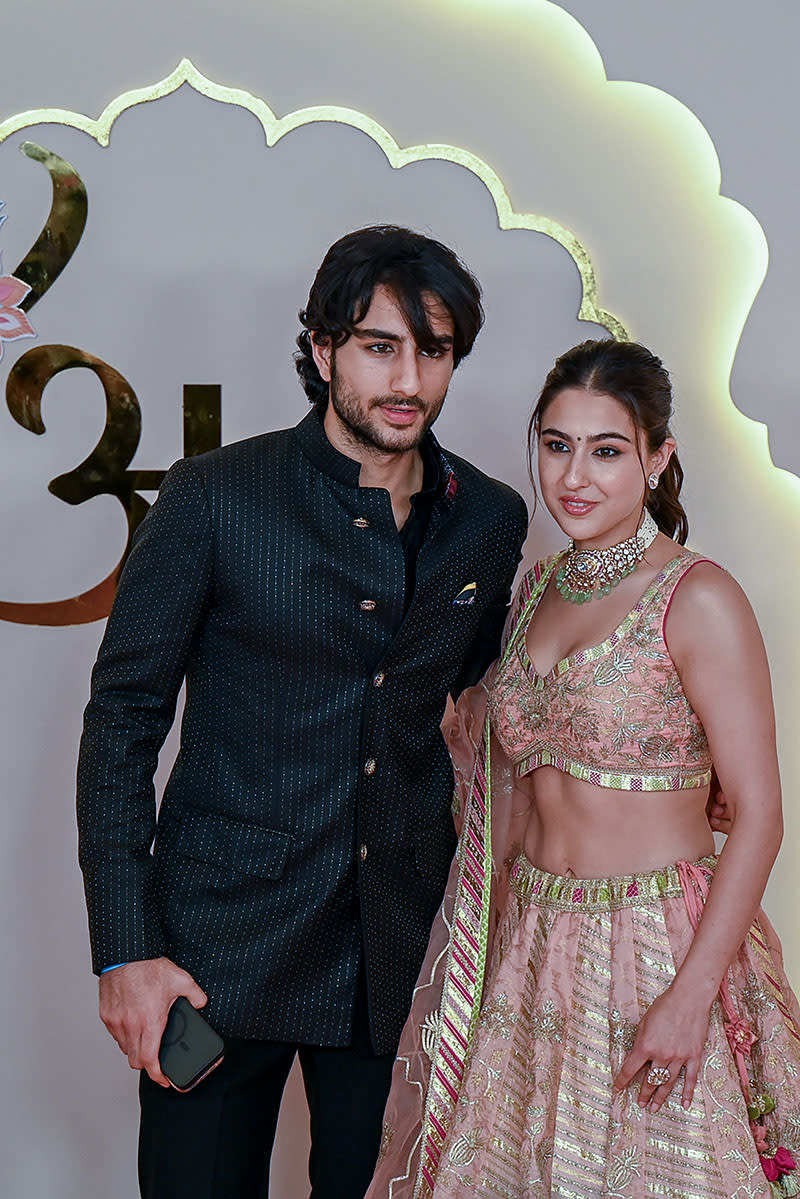 Bollywood actress Sara Ali Khan (R) and his brother Ibrahim Ali Khan pose for photos as they arrive to attend the wedding ceremony of billionaire tycoon and Chairman of Reliance Industries Mukesh Ambani's son Anant Ambani and Radhika Merchant in Mumbai on July 12, 2024. Socialite sisters Kim and Khloe Kardashian were among the global celebrities spotted in India on July 12 to attend a lavish three-day wedding ceremony staged by Asia's richest man Mukesh Ambani. (Photo by Punit PARANJPE / AFP) (Photo by PUNIT PARANJPEPUNIT PARANJPE/AFP via Getty Images)