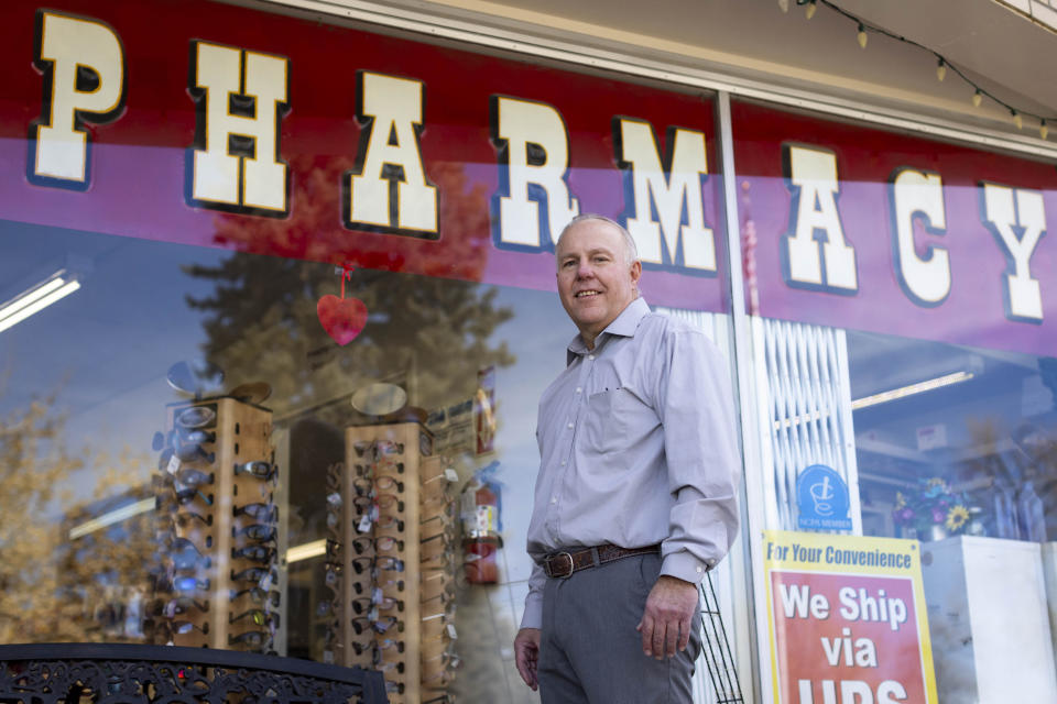 Craig Jones stands for a portrait in front of Basin Pharmacy in Basin, Wyo., on Wednesday, Feb. 21, 2024. It’s the key health care access point for the town of about 1,300 people and the surrounding area. (AP Photo/Mike Clark)