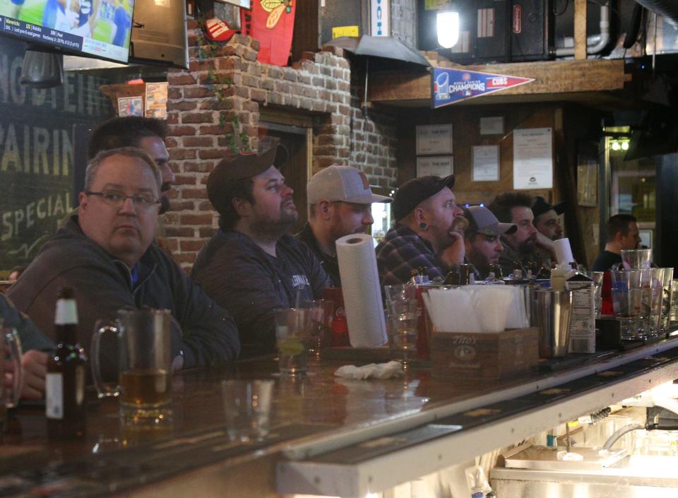 Fans at DT Kirby's cheer stare at the TV screens as the Purdue University Boilermakers lose to the Michigan Wolverines in Big Ten Championship, with a score of 43-22, on Saturday, Dec. 3, 2022, in Lafayette, Ind.