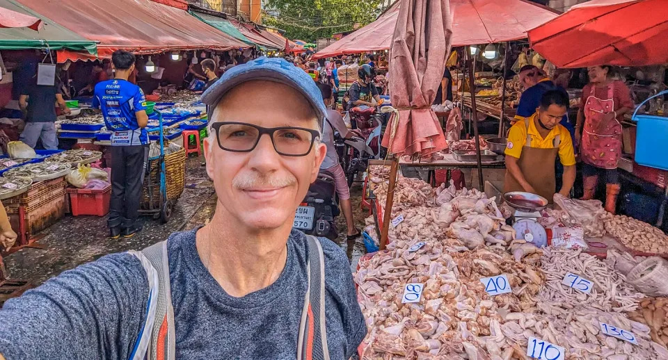 Michael standing in front of pile of raw chicken