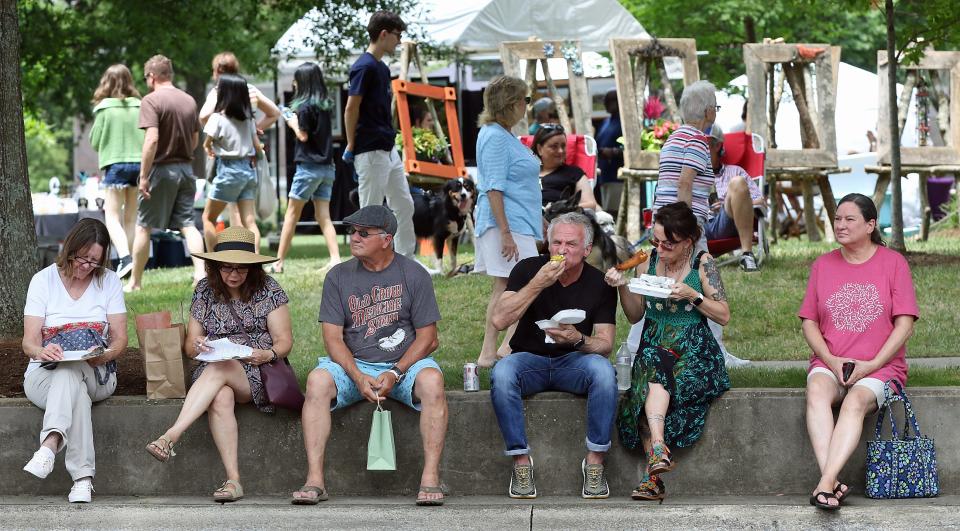 People line the street as they watch “Medicine Crow” perform on stage during the Art of Sound, Arts on the Square and  Flea Fest held Saturday, June 25, 2022, in Uptown Shelby.