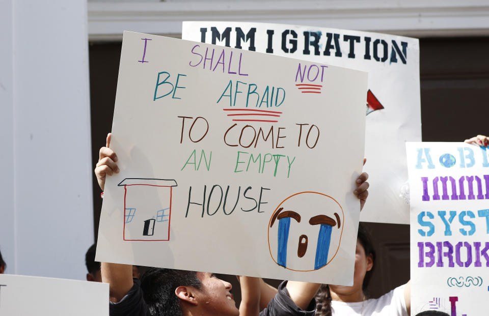 CORRECTS TO SAY THE RAIDS WERE WEDNESDAY, NOT TUESDAY - Children of mainly Latino immigrant parents hold signs in support of them and those individuals picked up during an immigration raid at a food processing plant in Canton, Miss., following a Spanish Mass at Sacred Heart Catholic Church in Canton, Miss., Sunday, Aug. 11, 2019. The raids Wednesday, at seven poultry plants in Mississippi have spurred churches, that have been key to providing spiritual and emotional comfort to workers to now step up to provide material aid to jailed or out-of-work church members. (AP Photo/Rogelio V. Solis)