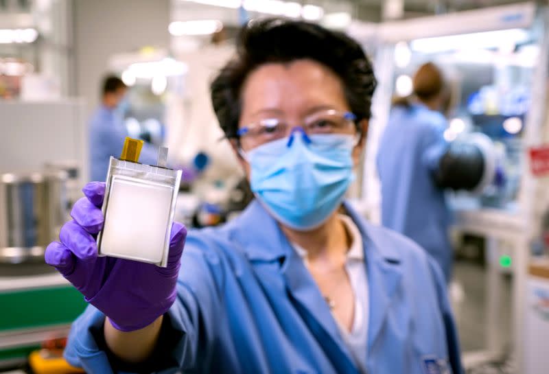 FILE PHOTO: A GM employee poses with an example of the company's next-generation lithium metal batteries