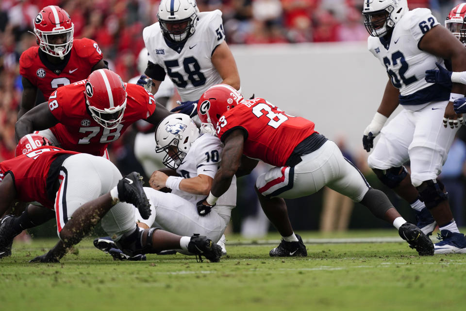 Samford quarterback Michael Hiers (10) is stopped by Georgia defenders Tramel Walthour (90), Nazir Stackhouse (78), and Robert Beal Jr. (33) during the first half of an NCAA college football game, Saturday, Sept. 10, 2022 in Athens, Ga. (AP Photo/John Bazemore)