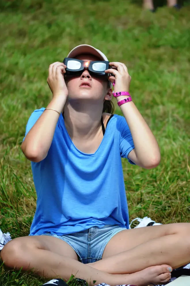 Lucy Sisto, then 11, of Millis, looks up to the sky to view the August 2017 solar eclipse at Moose Hill Wildlife Sanctuary in Sharon.