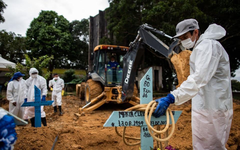 Several people work at the burial of a covid-19 victim at the Nossa Senhora Aparecida Cemetery, in Manaus, Brazil. The country is witnessing another explosion of cases - RAPHAEL ALVES/EPA-EFE/Shutterstock