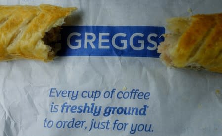 A sausage roll is seen on top of a bag at a Greggs bakery in Manchester
