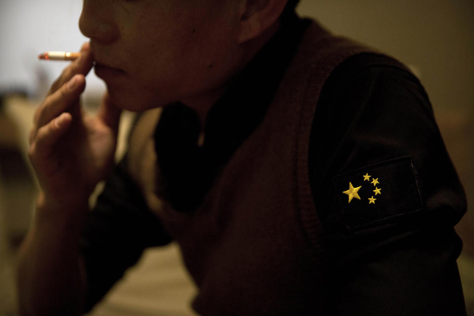 In this March 27, 2019, photo, Yin Hao, who also goes by Yin Qiang, smokes a cigarette while talking about his Tylox addiction in a restaurant in Xi'an, northwestern China's Shaanxi Province. Officially, pain pill abuse is an American problem, not a Chinese one. But people in China have fallen into opioid abuse the same way many Americans did, through a doctor's prescription. And despite China's strict regulations, online trafficking networks, which facilitated the spread of opioids in the U.S., also exist in China. (AP Photo/Mark Schiefelbein)