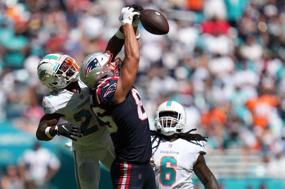 Miami Dolphins cornerback Kader Kohou (28) breaks up a pass intended for New England Patriots tight end Hunter Henry (85) on fourth down in the fourth quarter of an NFL game at Hard Rock Stadium in Miami Gardens, Sept. 11, 2022. 