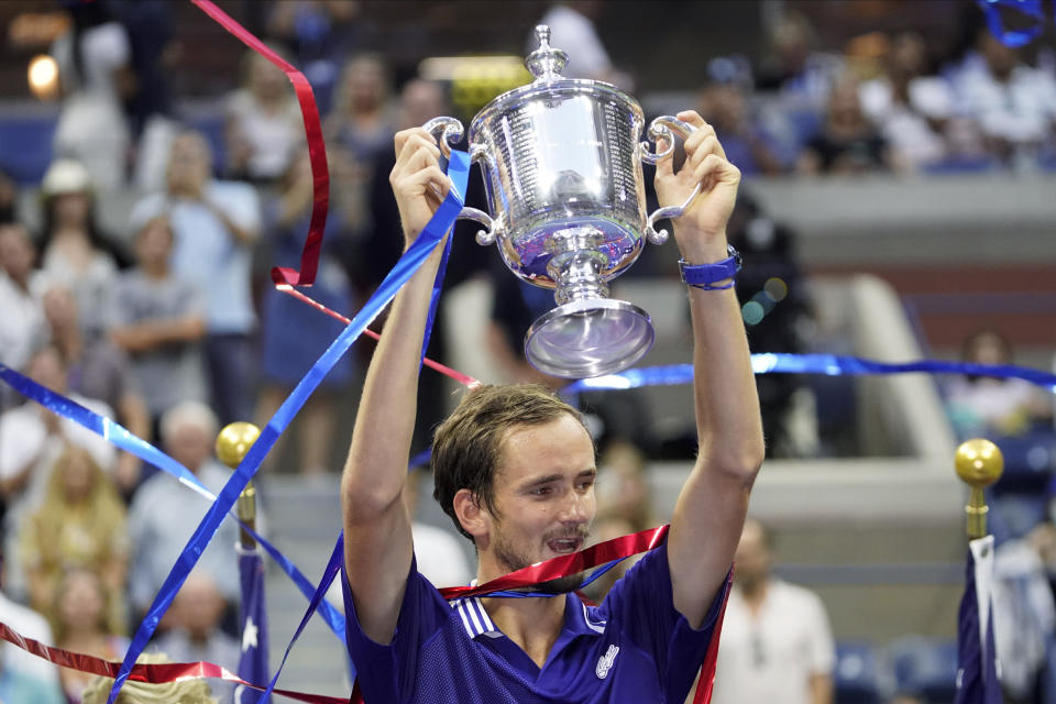 Daniil Medvedev, of Russia, holds up the championship trophy after defeating Novak Djokovic, of Serbia, in the men's singles final of the US Open tennis championships, Sunday, Sept. 12, 2021, in New York. (AP Photo/John Minchillo)