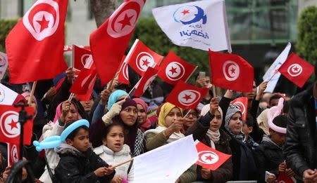 People wave national flags during celebrations marking the sixth anniversary of Tunisia's 2011 revolution in Habib Bourguiba Avenue in Tunis, Tunisia January 14, 2017. REUTERS/Zoubeir Souissi