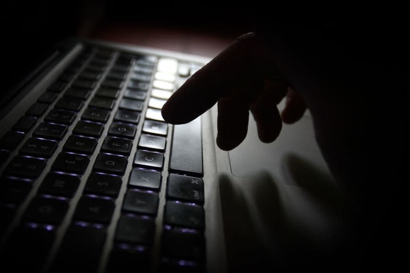 A man operates a laptop. The interior ministers of Germany's federal states are examining whether to introduce a separate criminal offence for cyberbullying. Karl-Josef Hildenbrand/dpa