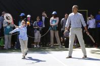 U.S. President Barack Obama plays tennis with children, one of the activities at the annual Easter Egg Roll at the White House in Washington April 6, 2015. REUTERS/Jonathan Ernst