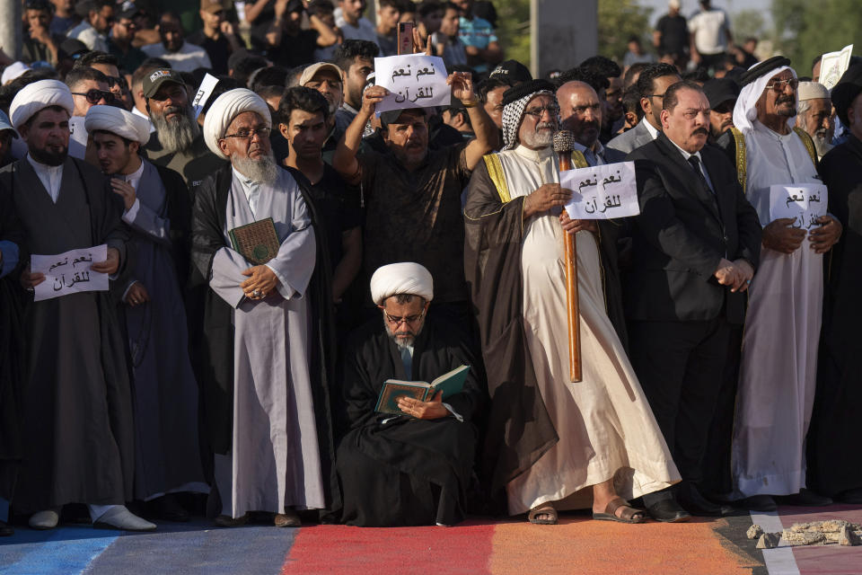 Supporters of Shiite Muslim leader Moqtada Sadr step on a LGBTQ+ rainbow flag in front of the Swedish embassy in Baghdad in response to the burning of Quran in Sweden, Baghdad, Iraq, Friday, June. 30, 2023. (AP Photo/Hadi Mizban)