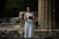 Olympics - Dress Rehearsal - Lighting Ceremony of the Olympic Flame Pyeongchang 2018 - Ancient Olympia, Olympia, Greece - October 23, 2017 Greek actress Katerina Lehou, playing the role of High Priestess, carries the Olympic Flame during the dress rehearsal for the Olympic flame lighting ceremony for the Pyeongchang 2018 Winter Olympic Games at the site of ancient Olympia in Greece REUTERS/Alkis Konstantinidis