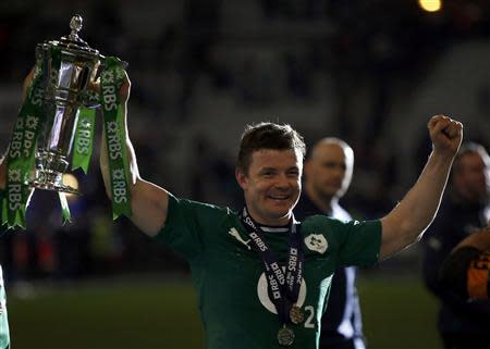 Ireland's Brian O'Driscoll holds the cup after his team defeated France in their Six Nations rugby union match at the Stade de France in Saint-Denis, near Paris, March 15, 2014. REUTERS/Gonzalo Fuentes