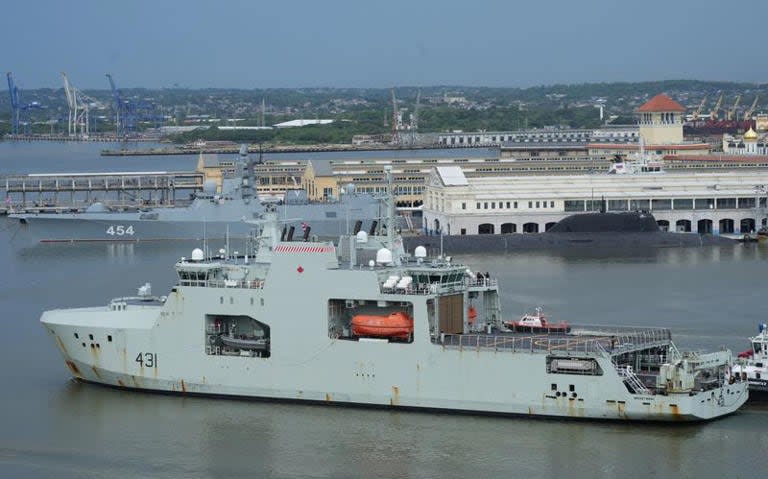 Canadian navy patrol boat HMCS Margaret Brooke passes by Russian nuclear-powered cruise missile submarine Kazan and frigate Admiral Gorshkov as it enters Havana's bay in Cuba on Friday. (Alexandre Meneghini/Reuters - image credit)