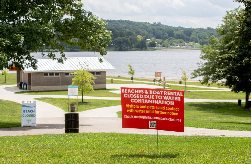 A sign reads the closure of The Maple Beach at Kensington Metropark in Milford Township, Michigan due to water contamination on Aug. 8, 2022. The hexavalent chromium release from the Tribar facility contaminated the Huron river, the Michigan EGLE testing is being done from Kent Lake at Kensington Metropark back to Wixom.