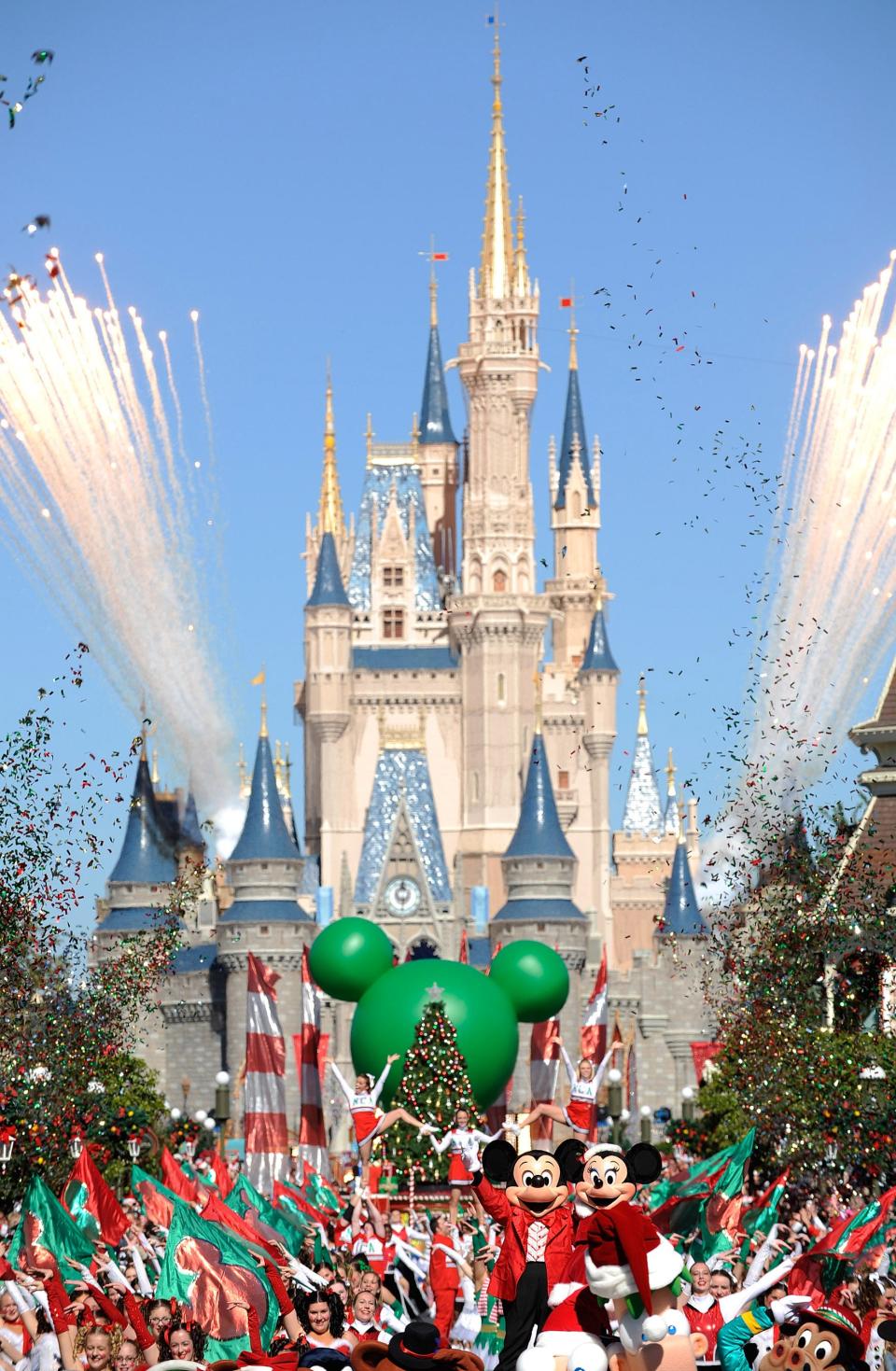 In this publicity image released by Disney, characters Mickey and Minnie Mouse wave as fireworks fly during a taping of the Disney Parks Christmas Day Parade special, Friday, Dec. 3, 2010, at the Magic Kingdom in Lake Buena Vista, Fla.  The annual holiday telecast will air on Dec. 25, on ABC. (AP Photo/Disney, Mark Ashman )