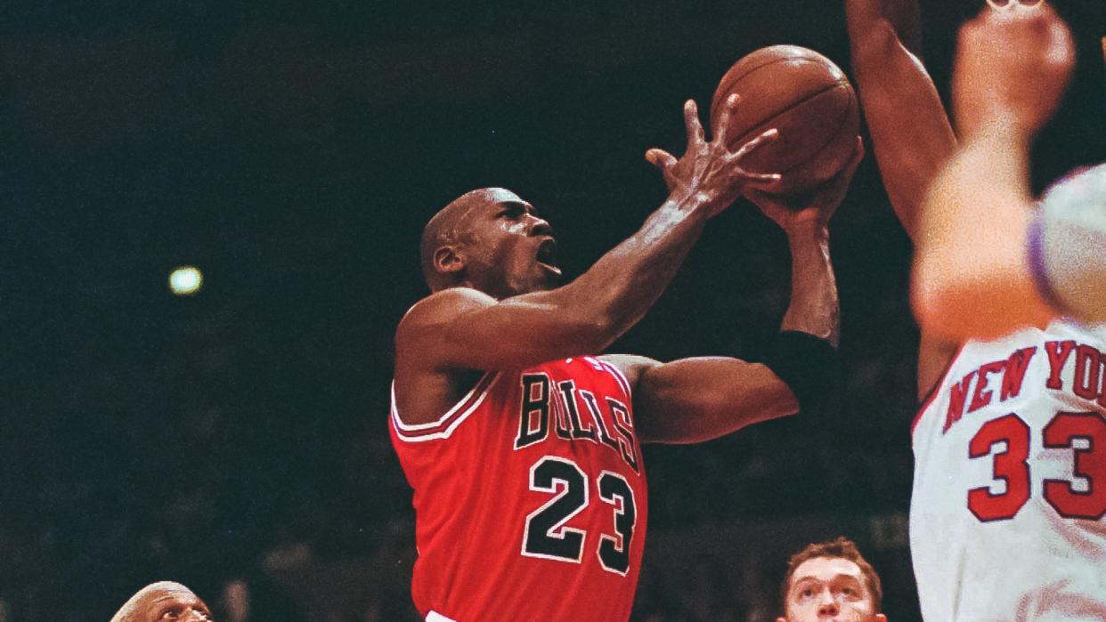 EWING Chicago Bulls guard Michael Jordan (23) drives to the basket in front of New York Knicks center Patrick Ewing (33) in the first half of game four of the Eastern Conference semi-finals Sunday evening at New York's Madison Square Garden.