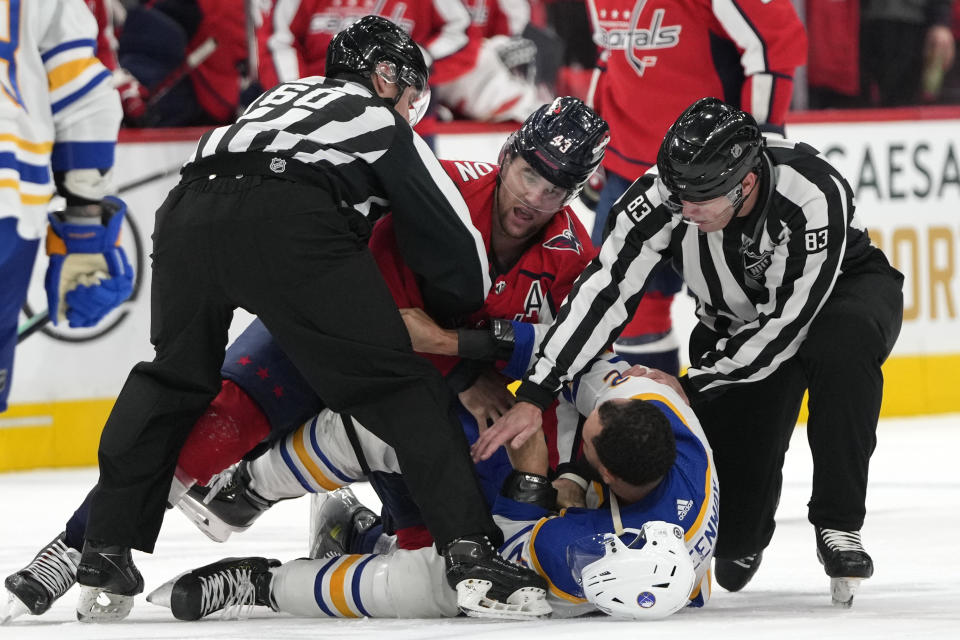 Washington Capitals right wing Tom Wilson, top, and Buffalo Sabres left wing Jordan Greenway, bottom, scuffle in the first period of an NHL hockey game, Wednesday, Nov. 22, 2023, in Washington. Both players received penalties for fighting on the play. (AP Photo/Mark Schiefelbein)