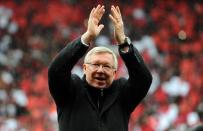 Manchester United's Scottish manager Alex Ferguson applauds as he arrives on the field during the English Premier League football match between Manchester United and Swansea City at Old Trafford in Manchester, northwest England, on May 12, 2013. United won 2-1