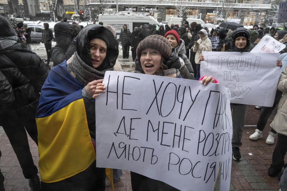 Activists hold a sign reading "I don't want a park where the Russians will kill me" during a protest in front of city council of Kyiv, Ukraine, Thursday, Dec. 14, 2023. 500 representatives of the territorial community of Kyiv and the "Money for the Ukrainian Armed Forces" initiative group came to the protest to support the Security and Defense Forces of Ukraine from the budget of Kyiv, which is filled at the expense of taxpayers, subventions and other revenues. (AP Photo/Evgeniy Maloletka)