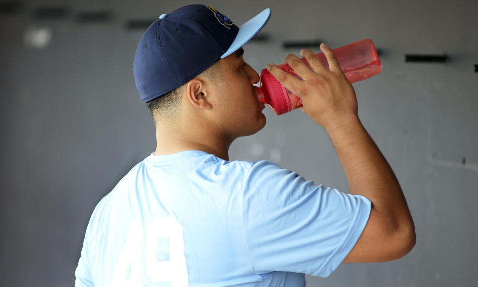 Trenton Thunder first baseman Rintaro Sasaki (49) has a drink before a baseball game against the Frederick Keys, Tuesday, June 11, 2024 , in Frederick, Md. The 19-year-old prospect will make his U.S. debut Tuesday in the MLB Draft League, playing for the Trenton Thunder of New Jersey along with others hoping to one day develop into major leaguers.(AP Photo/Daniel Kucin Jr.)