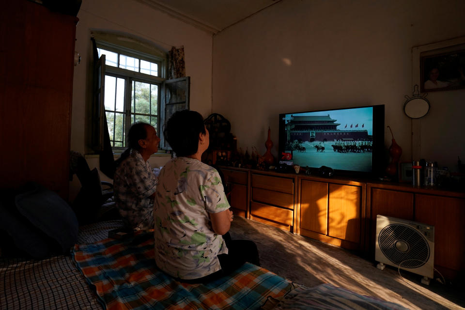 Residents watch on television the 1949 parade marking the establishment of People's Republic of China, before a military parade marking its 70th founding anniversary, on its National Day in Beijing, China October 1, 2019. (Photo: Aly Song/Reuters)