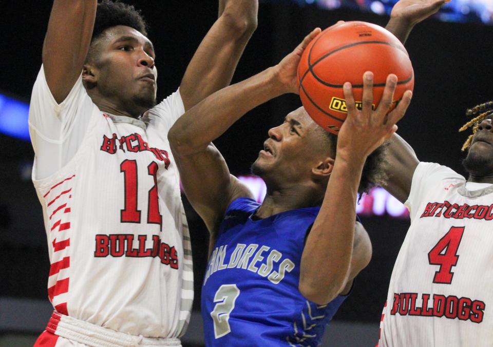 Childress' Lamont Nickleberry (middle) attempts to shoot against Hitchcock during the championship game of the Class 3A boys basketball tournament in the Alamodome at San Antonio on Saturday, March 11, 2023.