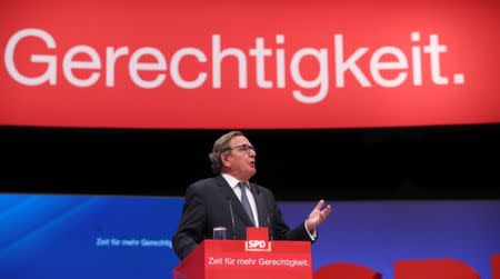 Former German Chancellor Gerhard Schroeder delivers his speech at the Social Democratic party (SPD) convention in Dortmund, Germany, June 25, 2017. The text reads "Justice". REUTERS/Wolfgang Rattay