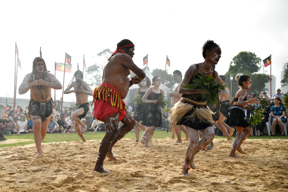 Koomurri dancers preform a smoking ceremony during the WugulOra Morning Ceremony on Australia Day at Walumil Lawns in Sydney.