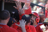 Los Angeles Angels' Anthony Rendon celebrates with teammates after scoring during the first inning of a spring training baseball game against the Cincinnati Reds, Tuesday, Feb. 25, 2020, in Tempe, Ariz. (AP Photo/Darron Cummings)