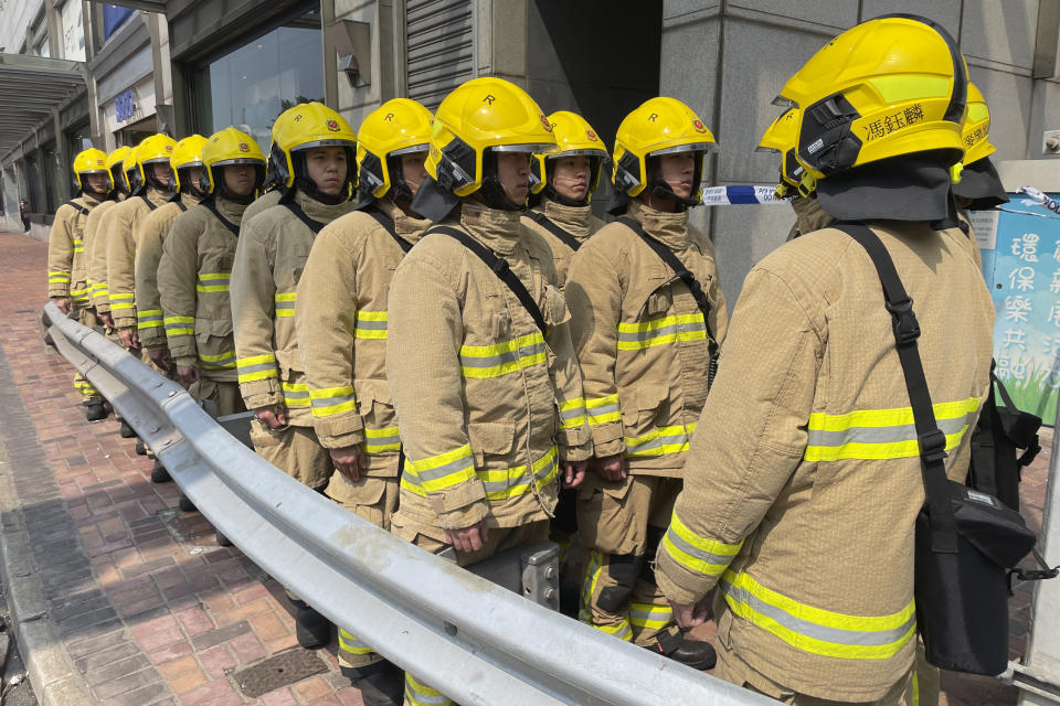 Firefighters gather near the site of a high-rise fire in Hong Kong, Friday, March 3, 2023. Hong Kong firefighters battled a blaze Friday that broke out overnight at a construction site in a popular shopping district and forced around people in nearby buildings to evacuate. (AP Photo)