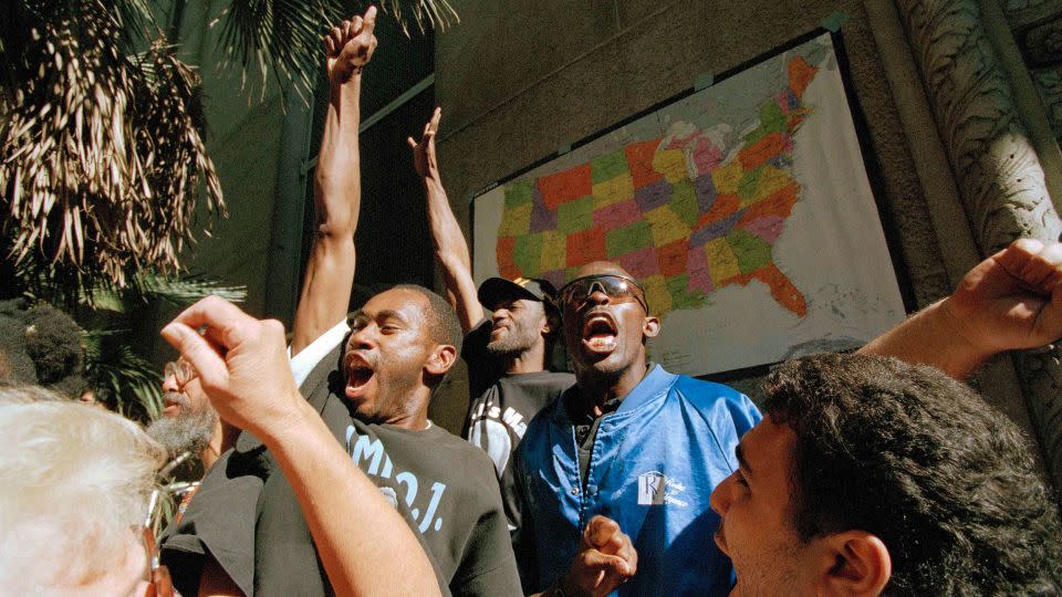 Supporters of O.J. Simpson react outside the Criminal Courts Building to the not guilty verdict in Simpson's murder trial on October 3, 1995, in Los Angeles. - Elise Amendola/AP