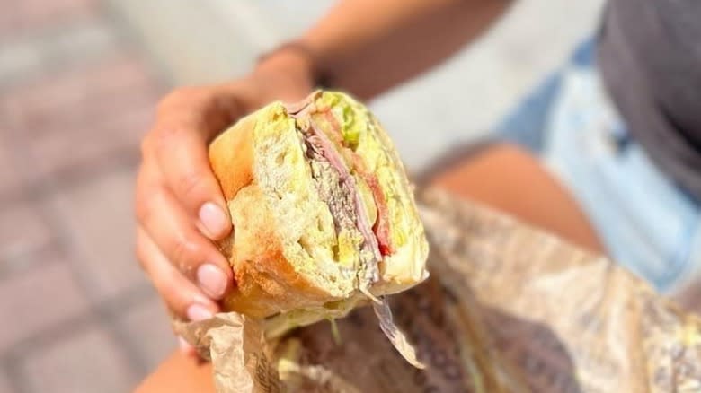 Hand holding Cuban sandwich