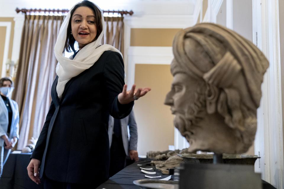 Afghan Ambassador to the U.S. Roya Rahmani, accompanied by embassy staff, speaks as she gives the Associated Press a tour at the Afghanistan Embassy in Washington, Wednesday, April 21, 2021, of looted and stolen Afghan religious relics and antiquities recovered by U.S. government authorities as part of a wider investigation into global trafficking in rare and ancient artifacts. (AP Photo/Andrew Harnik)