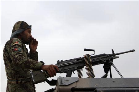 An Afghan National Army soldier keeps watch near the site of a gunfight on the outskirts of Kabul October 26, 2013. REUTERS/Mohammad Ismail