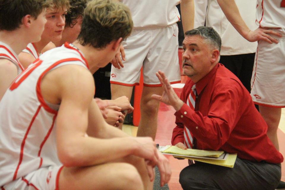 DCG head coach Joel Rankin talks to his players during a game against Pella on Friday, Feb. 10, 2023, in Grimes.