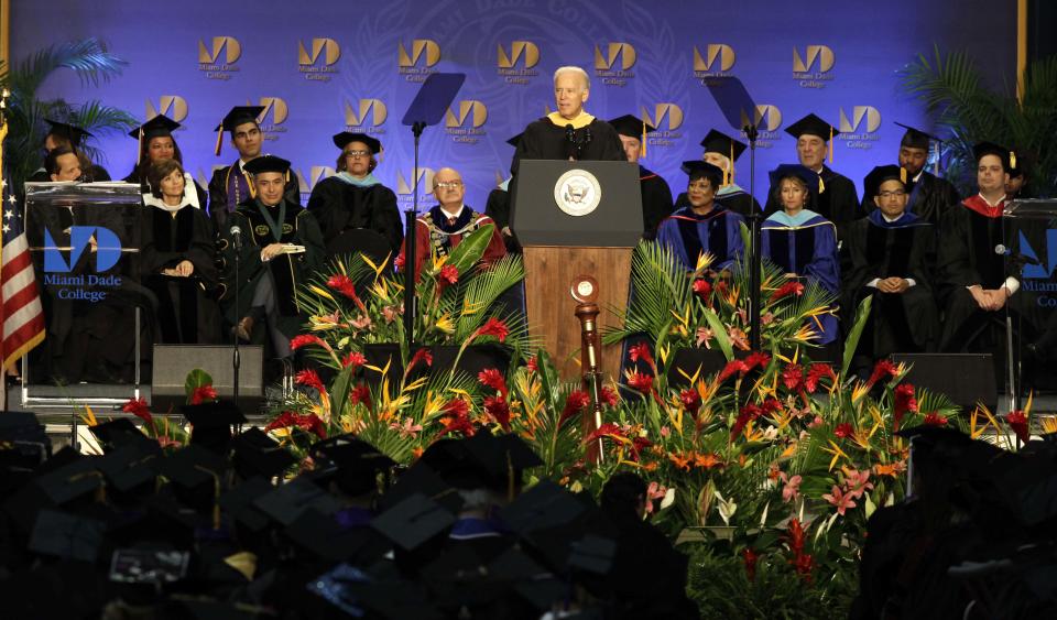 Vice President Joe Biden, center, speaks during a graduation ceremony at the Miami Dade College in Miami, Saturday, May 3,2014. Biden said a "constant, substantial stream of immigrants" is important to the American economy, urging citizenship for immigrants living in the U.S. illegally. (AP Photo/Javier Galeano)