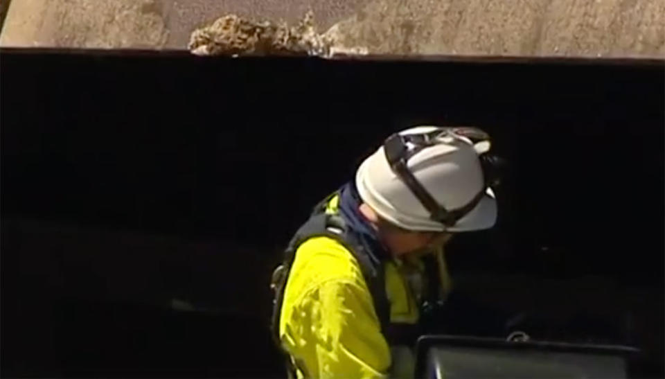 A worker inspects the damage. Source: 7 News