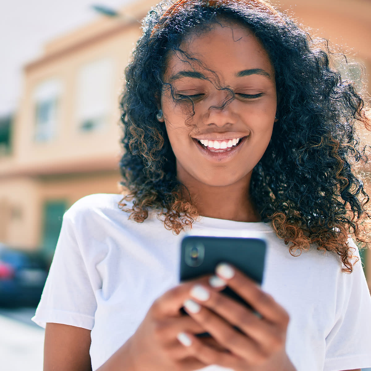 happy-young-woman-using-iphone