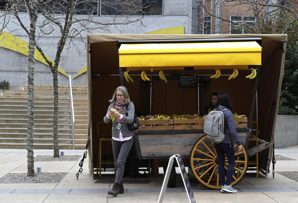 Free bananas are given out from one of Amazon.com's well-known banana stands at a plaza between two Amazon.com office buildings, Tuesday, Nov. 13, 2018, in Seattle's South Lake Union neighborhood. Amazon ended its competition for a second headquarters Tuesday by selecting New York and Arlington, Va., as the joint winners. (AP Photo/Ted S. Warren)