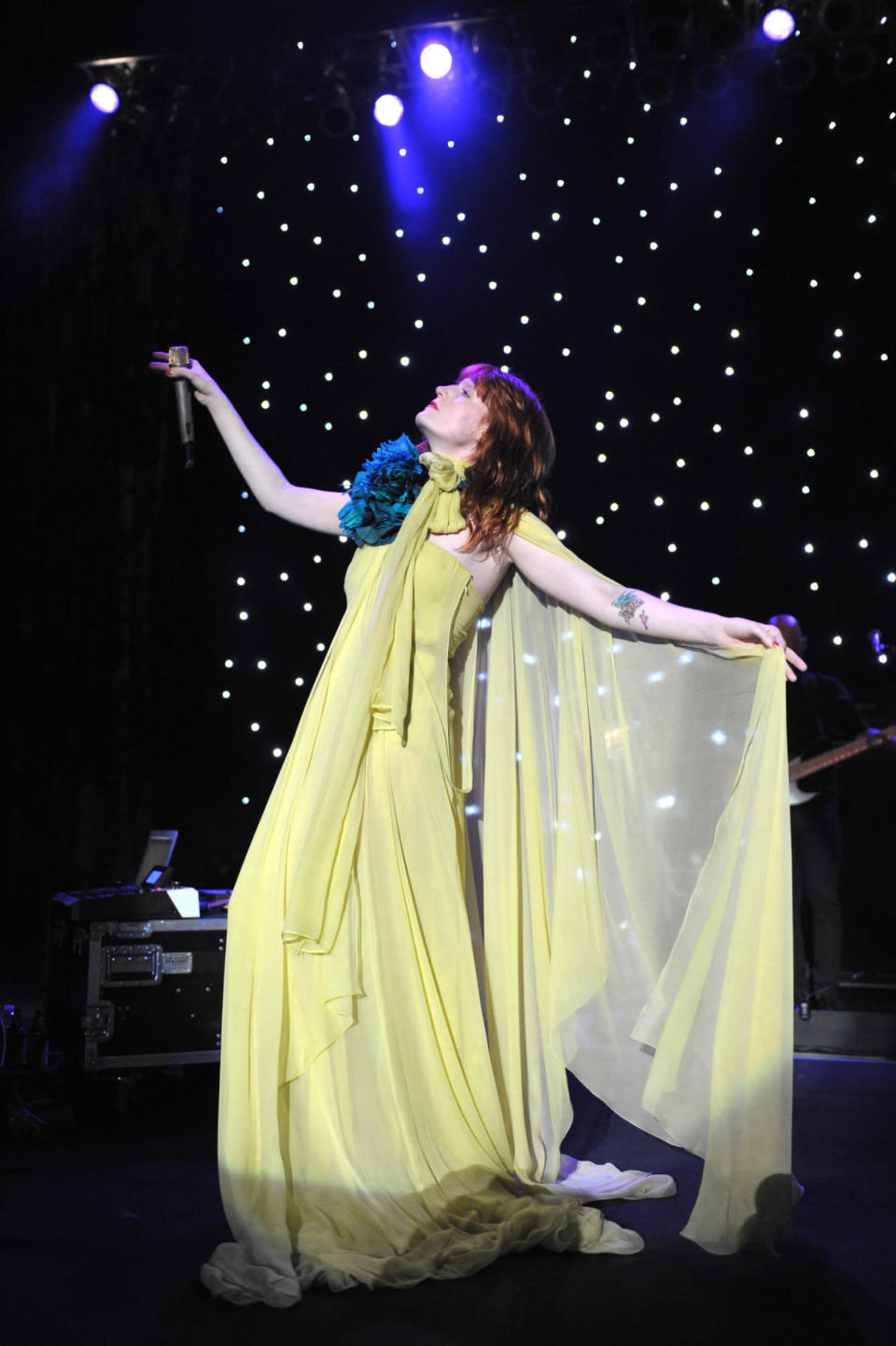 Florence Welch performs in a citron Gucci gown at a concert in 2011. 