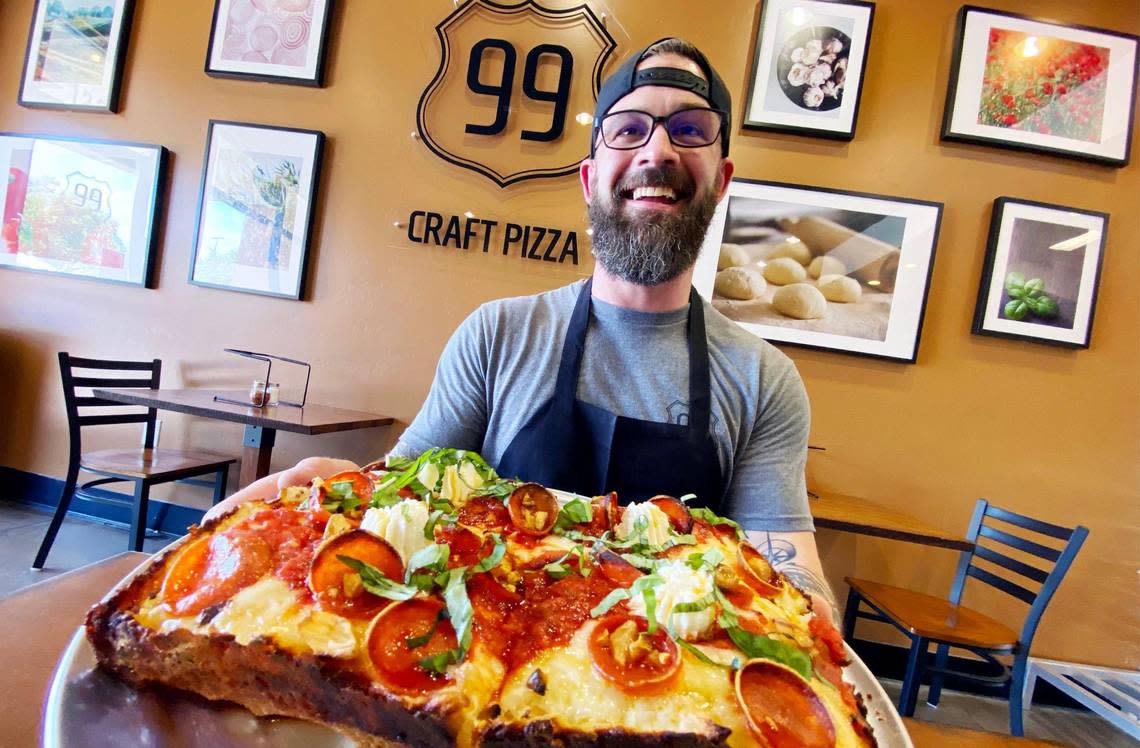 Steve McCrary, partner and general manager at the newly opened 99 Craft Pizza, shows off the Detroit-style Pinnacles PBR pepperoni pizza with fresh basil, drizzled hot honey and ricotta cheese. Photographed Wednesday, Aug. 3, 2022 in Fresno.