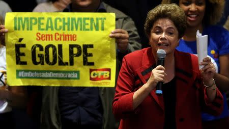 Brazil's suspended President Dilma Rousseff attends a meeting with people from pro-democracy movements in Sao Paulo, Brazil, August 23, 2016. The banner reads "Impeachment without crime is coup". REUTERS/Paulo Whitaker