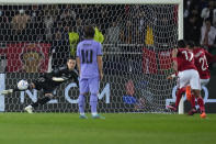 Al Ahly's Ali Maaloul, right, scores his side's opening goal from penalty spot during the FIFA Club World Cup semi final match between Al Ahly and Real Madrid at Prince Moulay Abdellah stadium in Rabat, Morocco, Wednesday, Feb. 8, 2023. (AP Photo/Manu Fernandez)