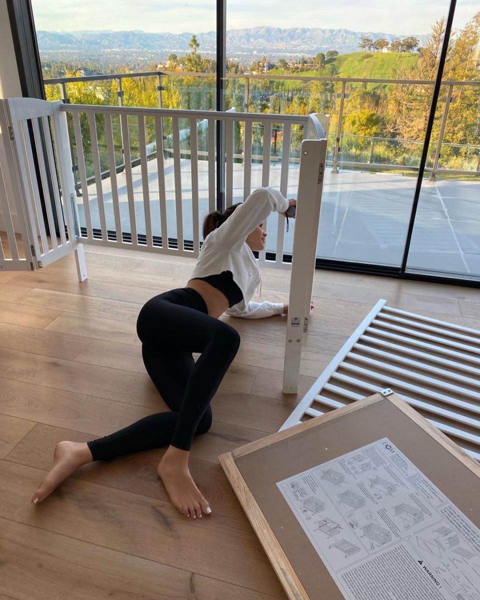 Olivia Culpo assembles a crib in spandex gym wear