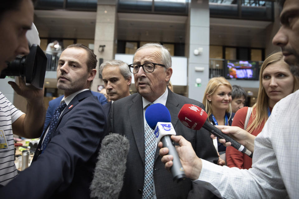 European Commission President Jean-Claude Juncker speaks to the media during an EU summit in Brussels, Friday, Oct. 18, 2019. After agreeing on terms for a new Brexit deal, European Union leaders are meeting again to discuss other thorny issues including the bloc's budget and climate change. (AP Photo/Virginia Mayo)