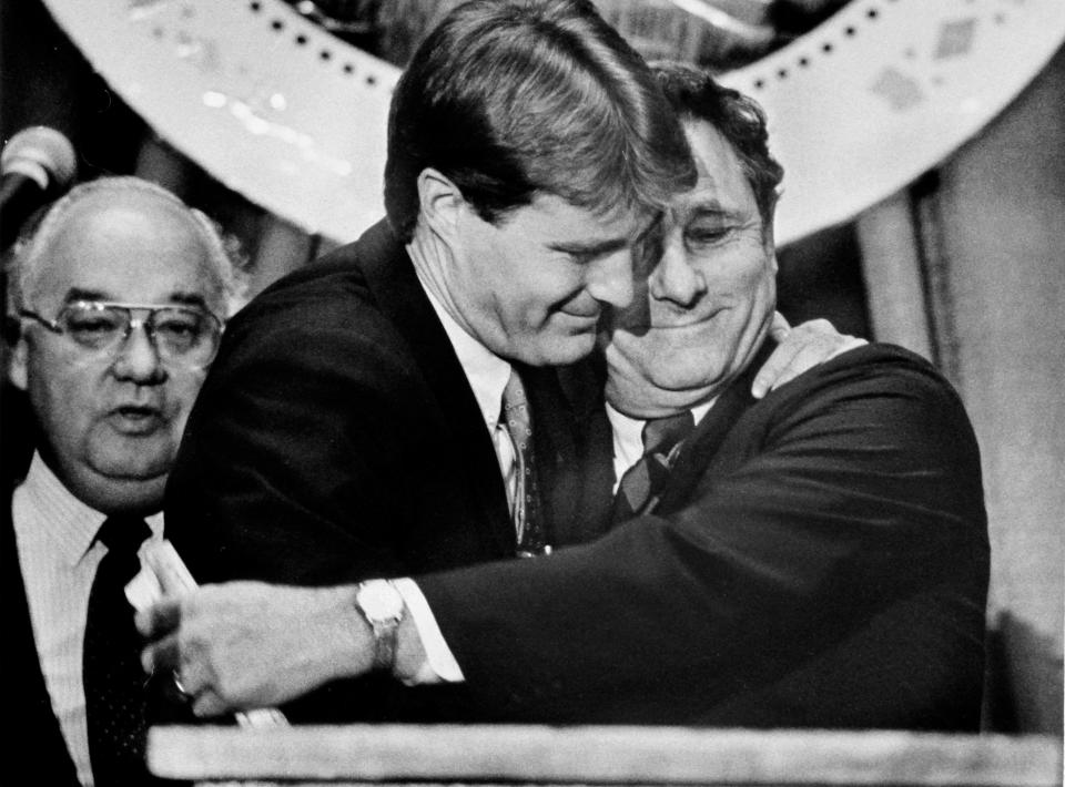 New Indiana governor Evan Bayh gets a hug from his father Birch Bayh, a former U.S. Senator from Indiana. This was just after a swearing in ceremony to make Evan Bayh Indiana governor on Dec. 1, 1986. Secretary of State Larry Conrad is seen in the background.